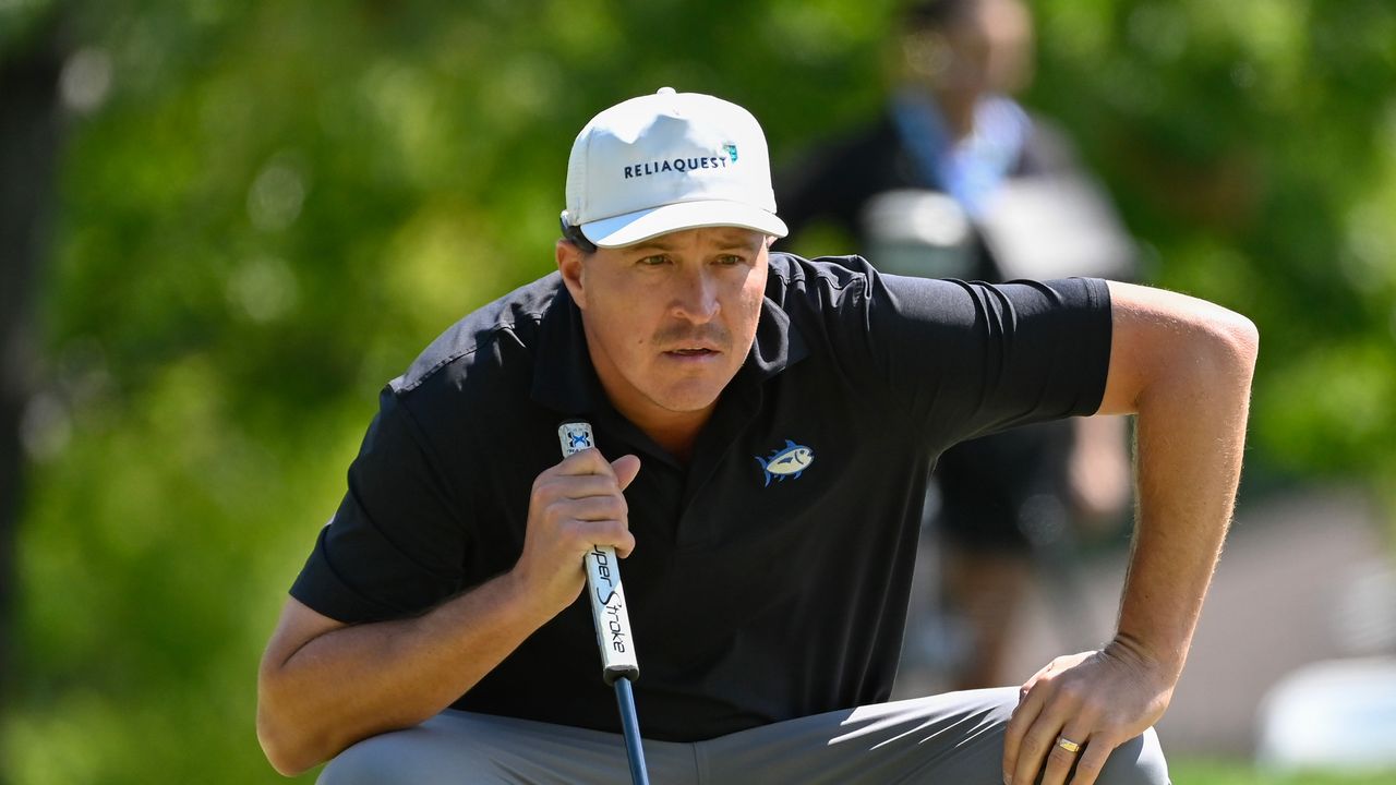 Kevin Roy crouches down behind a putt at the 2024 Albertsons Boise Open