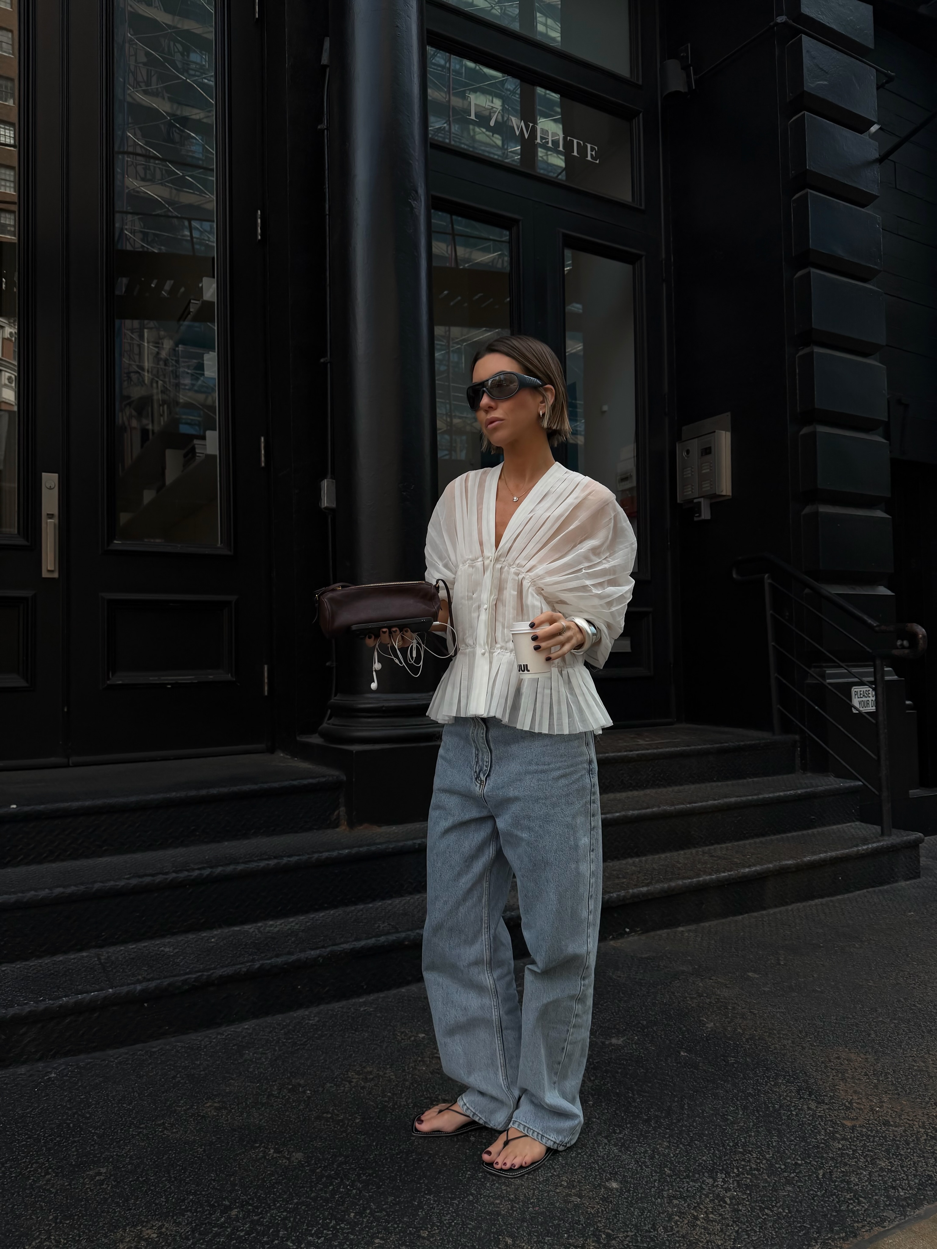 An image of a woman wearing jeans black sandals outfit 2026
