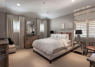 bedroom with grey walls mirror and mattress with cushion