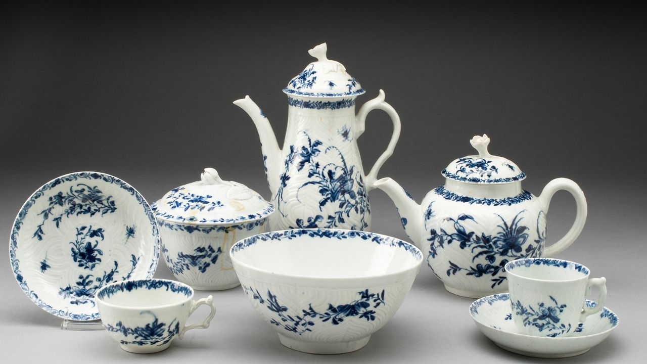 A white and blue floral tea set sittintg on a gray background