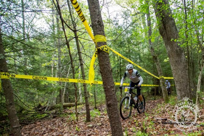 John Merriam rolls through a taped off section of singletrack in Stage 5