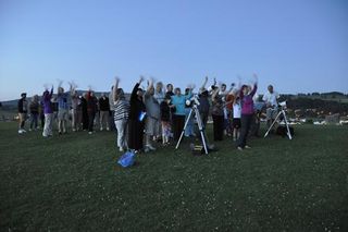 Telescopes, telephone and tablets at the ready, a group of amateur astronomers gathers under twilight skies to wave at Saturn on July 19, 2013.