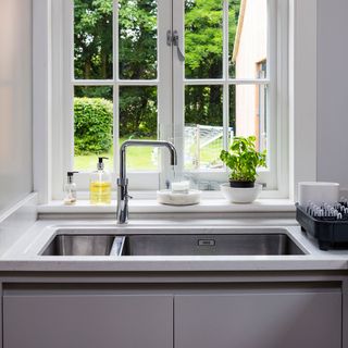 kitchen area with white window and wash basin