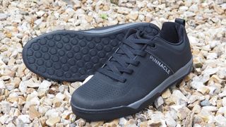 A pair of black flat pedal MTB shoes