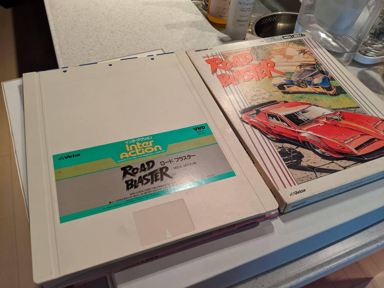 The tabs at the top will slide off, when entered into a player, so the vinyl disc inside can slip out.