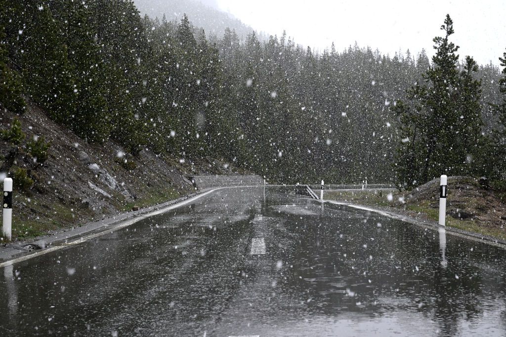 UMBRAIL PASS ITALY MAY 21 Rain and snow conditions at Umbrail Pass 2501m SwissItalian border during the 107th Giro dItalia 2024 Stage 16 a 121km stage from Prato di Stelvio to Santa Cristina Valgardena Monte Pana 1625m Route and stage modified due to adverse weather conditions UCIWT on May 21 2024 in Umbrail Pass Italy Photo by Dario BelingheriGetty Images
