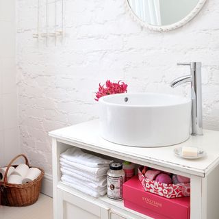 bathroom with white brick wall and wash basin