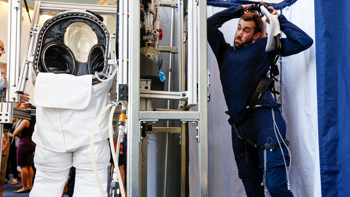 An engineer prepares to get into the prototype of Collins Aerospace, a unit of United Technologies Corp.'s Next Generation Space Suit system, unveiled during the Space Day on the Hill on Thursday, July 25, 2019 in Washington. The showcase was timed to commemorate the 50th Anniversary of Apollo 11.