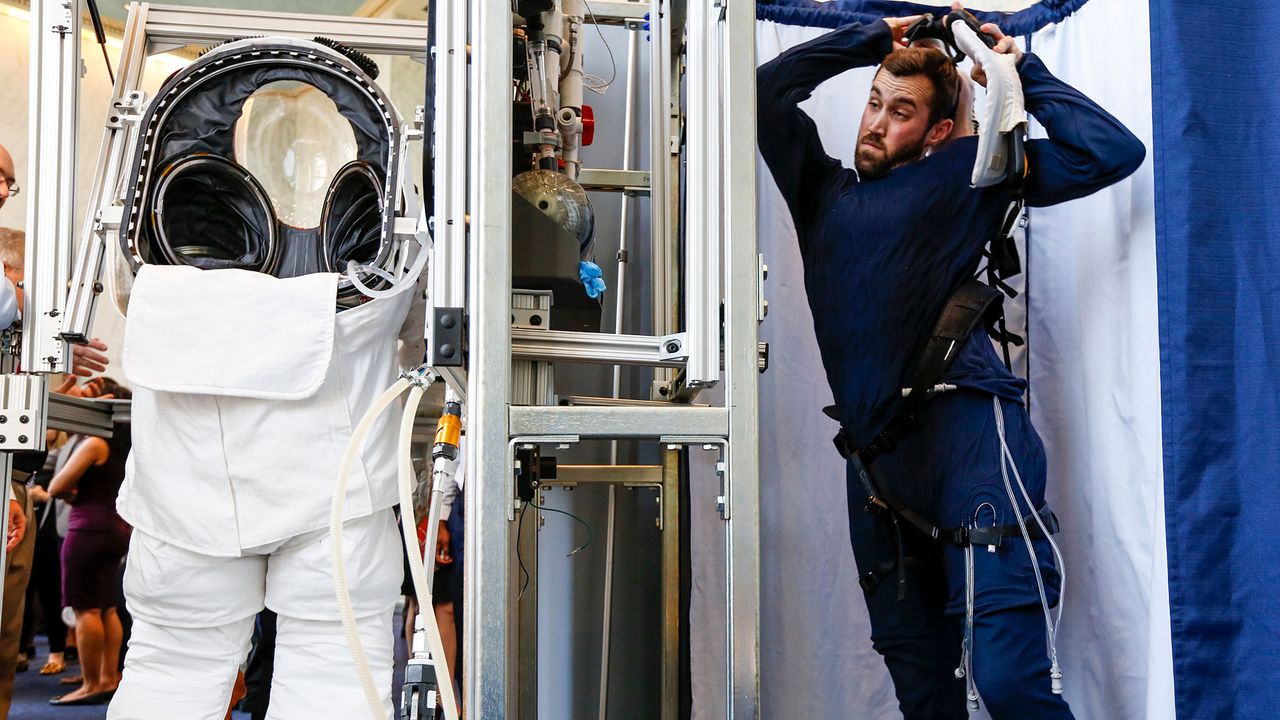 An engineer prepares to get into the prototype of Collins Aerospace, a unit of United Technologies Corp.'s Next Generation Space Suit system, unveiled during the Space Day on the Hill on Thursday, July 25, 2019 in Washington. The showcase was timed to commemorate the 50th Anniversary of Apollo 11.