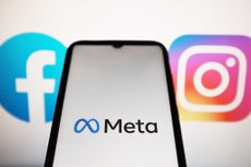 Meta logo seen displayed on a smartphone screen with Facebook and Instagram logos on a MacBook screen 