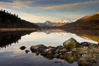 A view of a lake and snow-topped mountains in Snowdonia National Park
