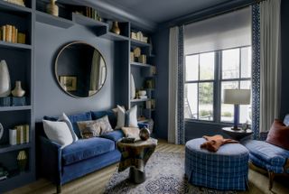 Blue living room with minimalist bookshelf styling