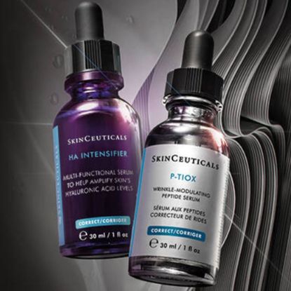 Two SkinCeuticals bottles on grey background