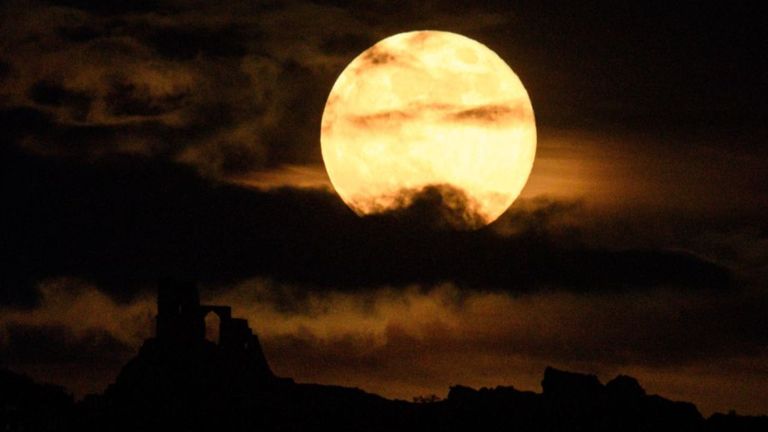 WOLF MOON: A supermoon rises over Mow Cop Castle near Stoke-on-Trent, central England on May 7, 2020. 