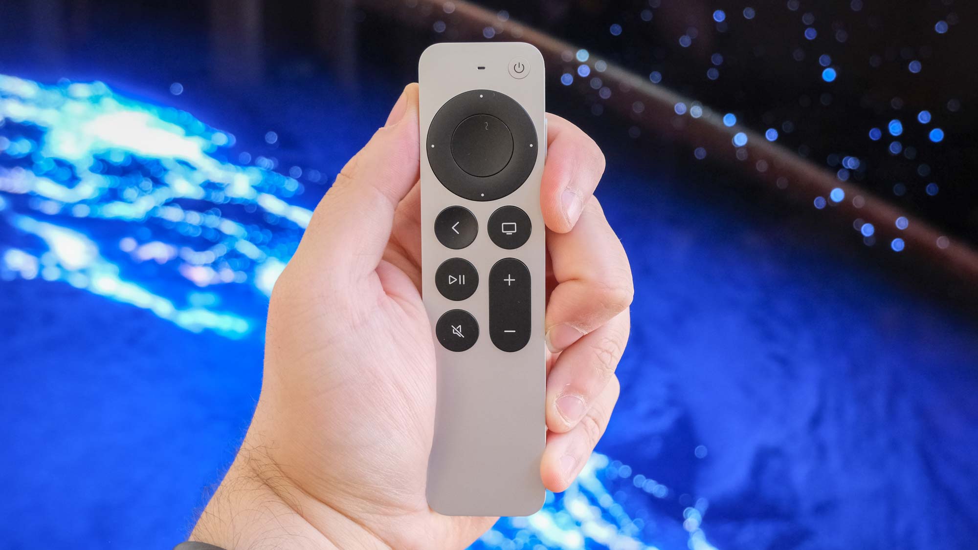 The Apple TV 4K (2022) remote in hand.