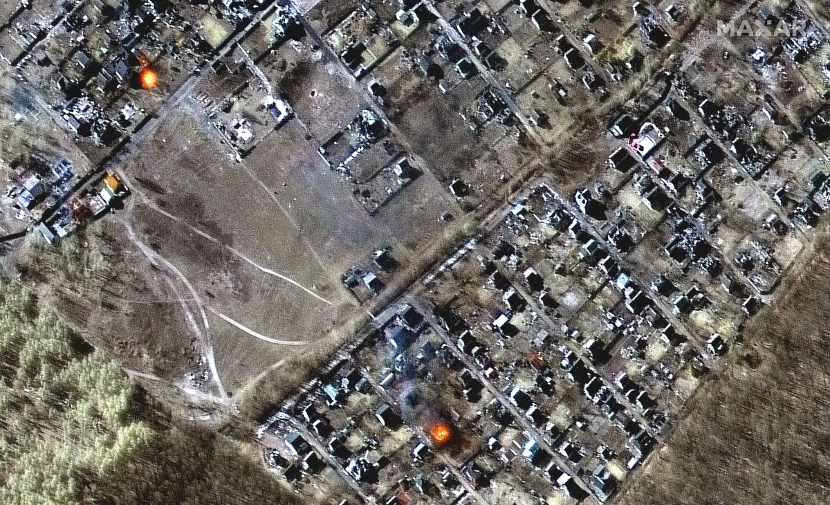 Multispectral and natural color images showing destroyed homes, impact craters and fires in town of Moschun on March 11, 2022 as seen by the WorldView-2 satellite for Maxar Technologies.