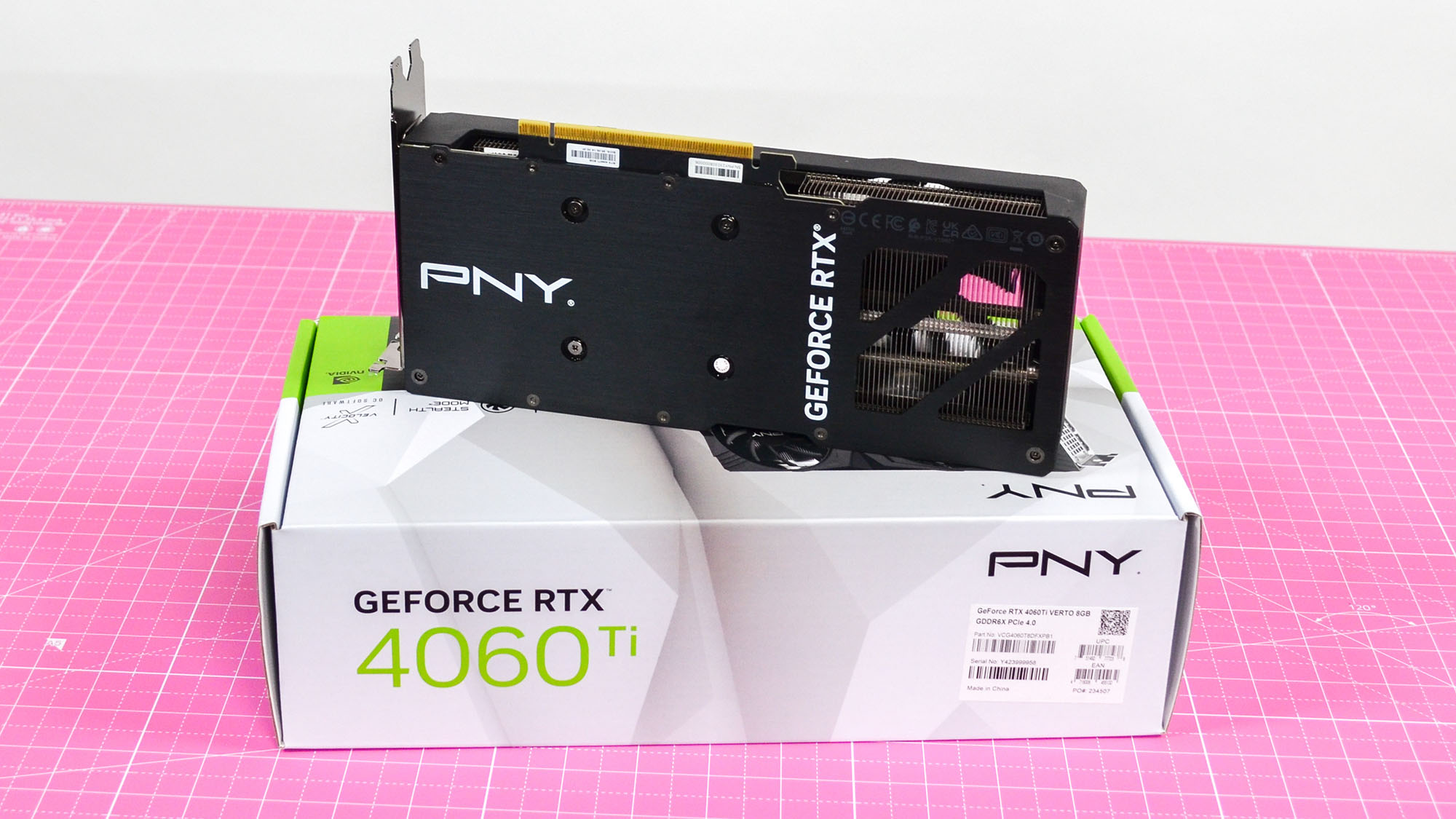 A PNY GeForce RTX 4060 Ti on a desk with a pink desk mat.