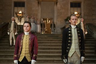 Sam Clemmett as Brimsley and Freddie Dennis as Reynolds in Queen Charlotte: A Bridgerton Story