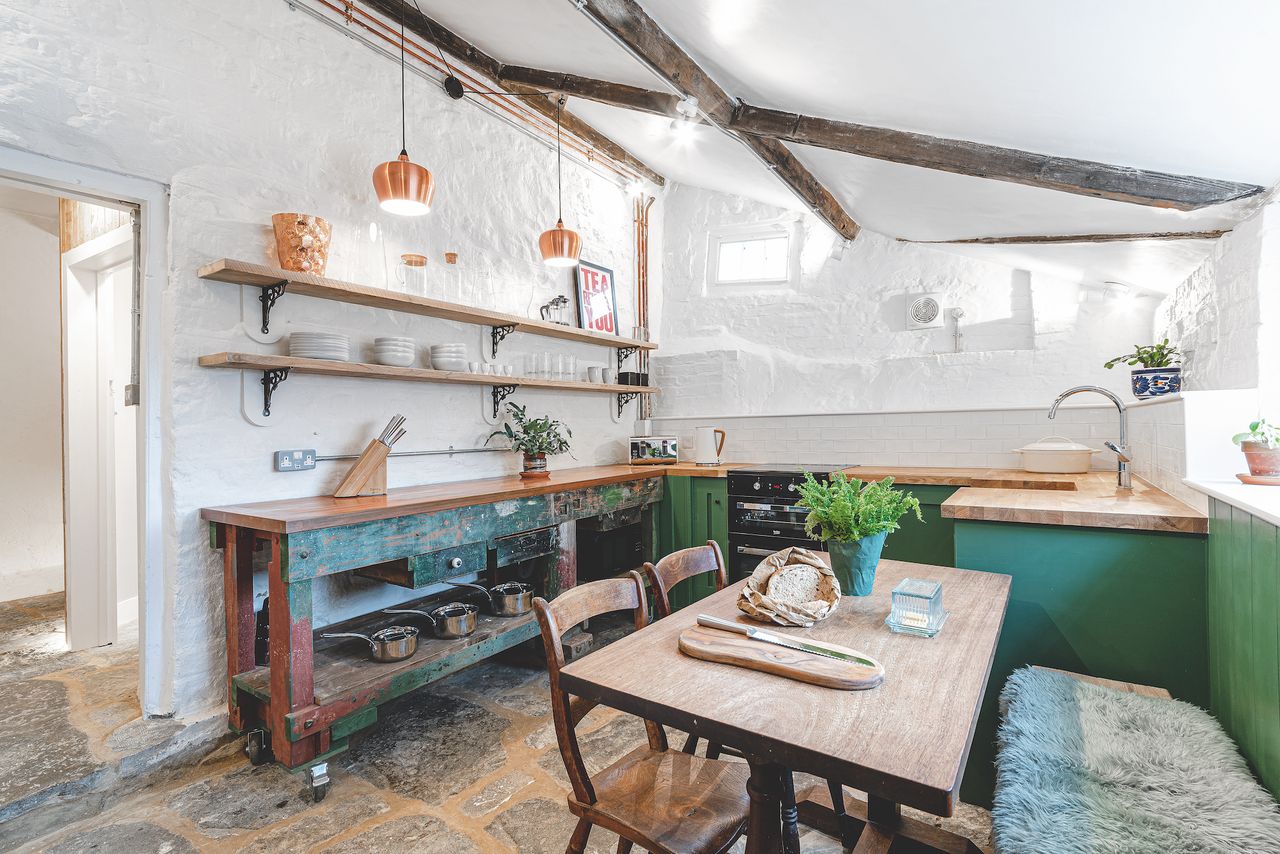 white and green kitchen with dining table