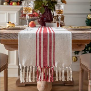 A Caflife Red Christmas Table Runner on a wooden table
