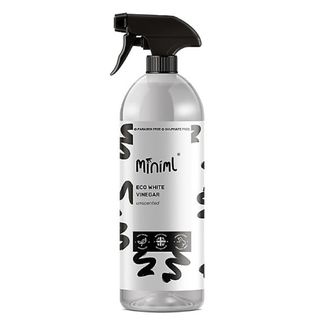 Clear spray bottle of miniml vinegar for cleaning