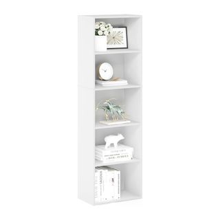 White stacked cubby style bookshelf on white background, filled with white books, clock, animal figurines 