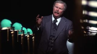 Ned Beatty delivers a big speech at the head of a conference table in Network,