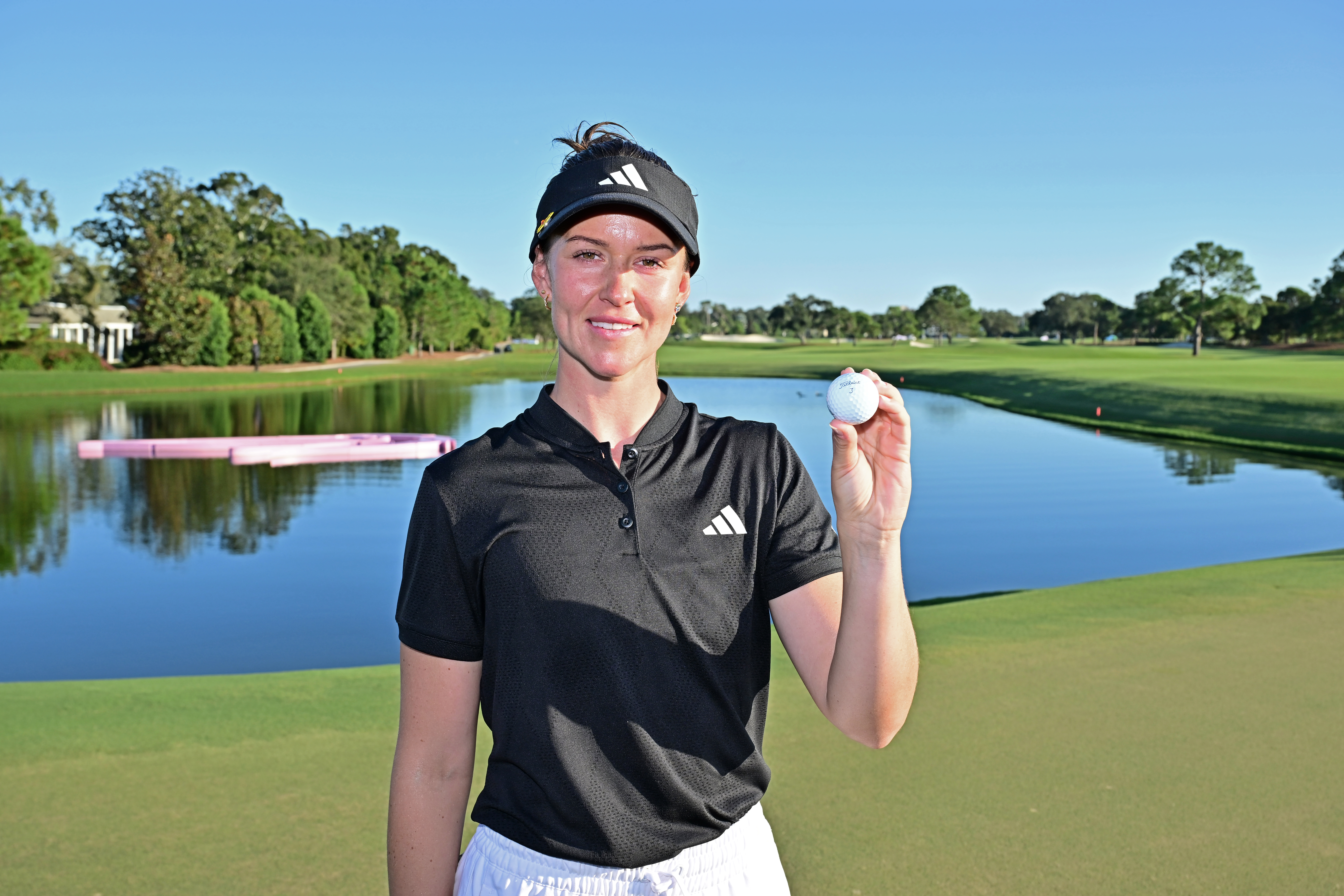 Linn Grant poses with her golf ball on the green