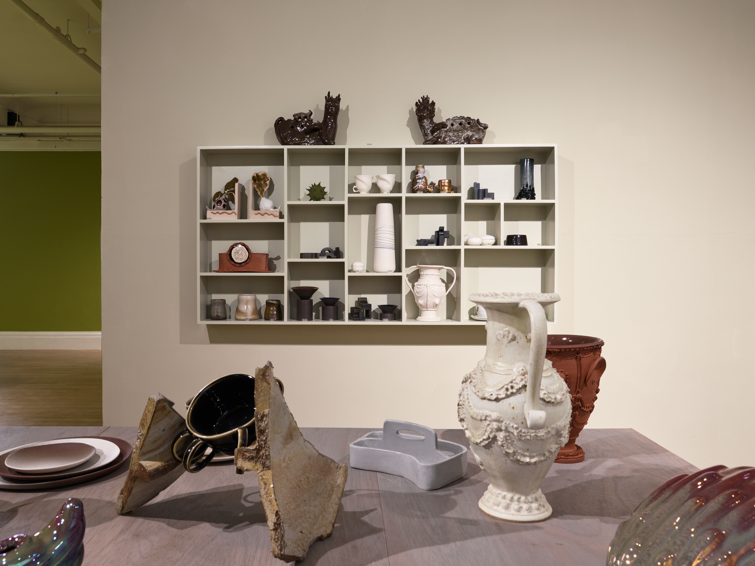 Futuristic ceramics in green gallery space