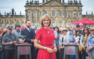 Antiques Roadshow Coronation Special host Fiona Bruce in a pink dress. 