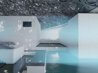 Play of light on water beneath intricate dome of Louvre Abu Dhabi