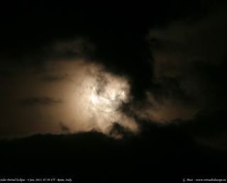 Astronomer Gianluca Masi of Italy took this photo of the partial solar eclipse of Jan. 4, 2011 as it appeared through eerie clouds over Rome.