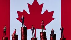 Illustrative photo showing small figures standing on a stack of coins, with the Canadian flag in the background