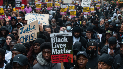 Large group of demonstrators march through London carrying signs reading ‘Justice for Chris’ and ‘Black Lives Matter’