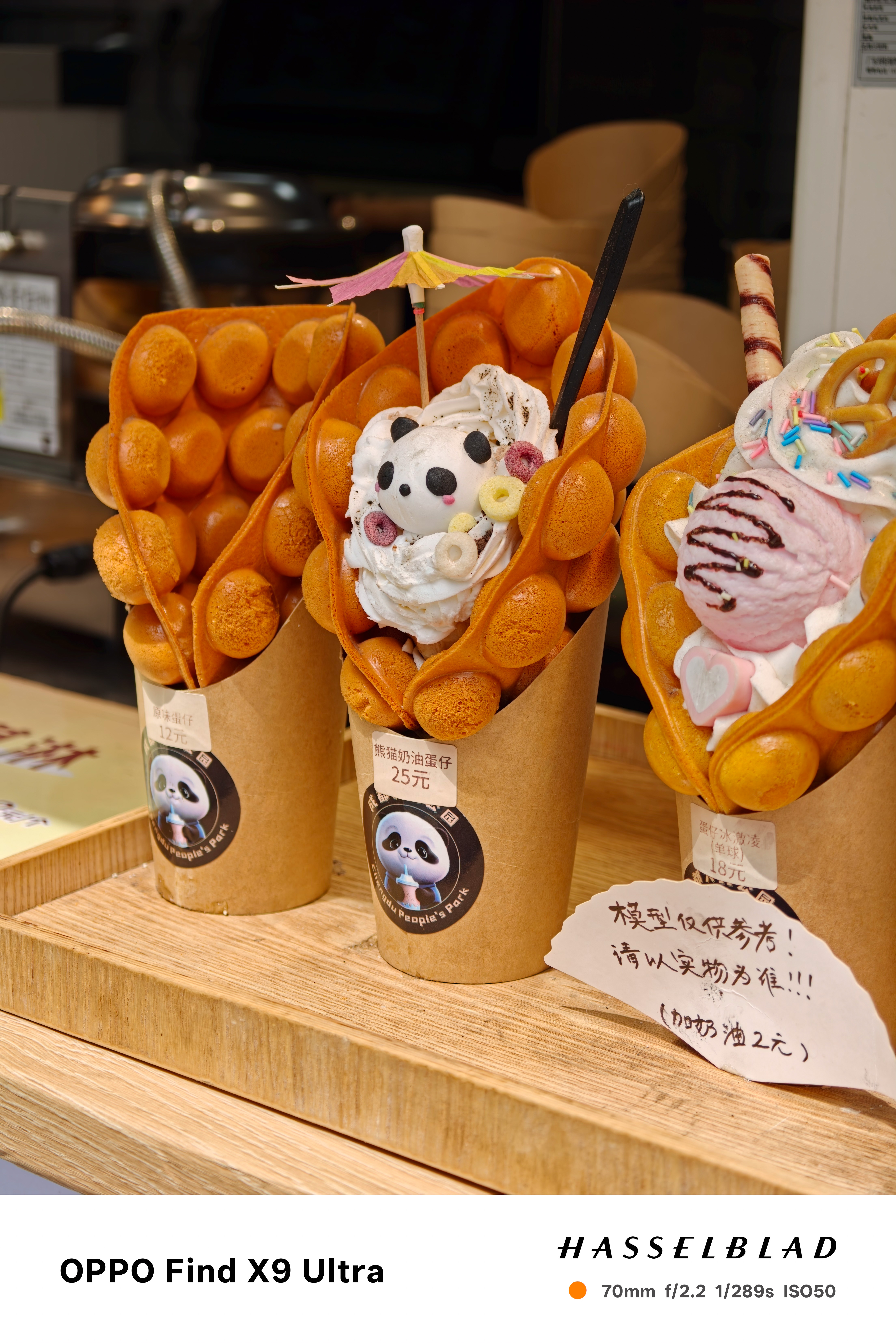 Bubble waffles filled with ice cream and toppings on a dessert counter