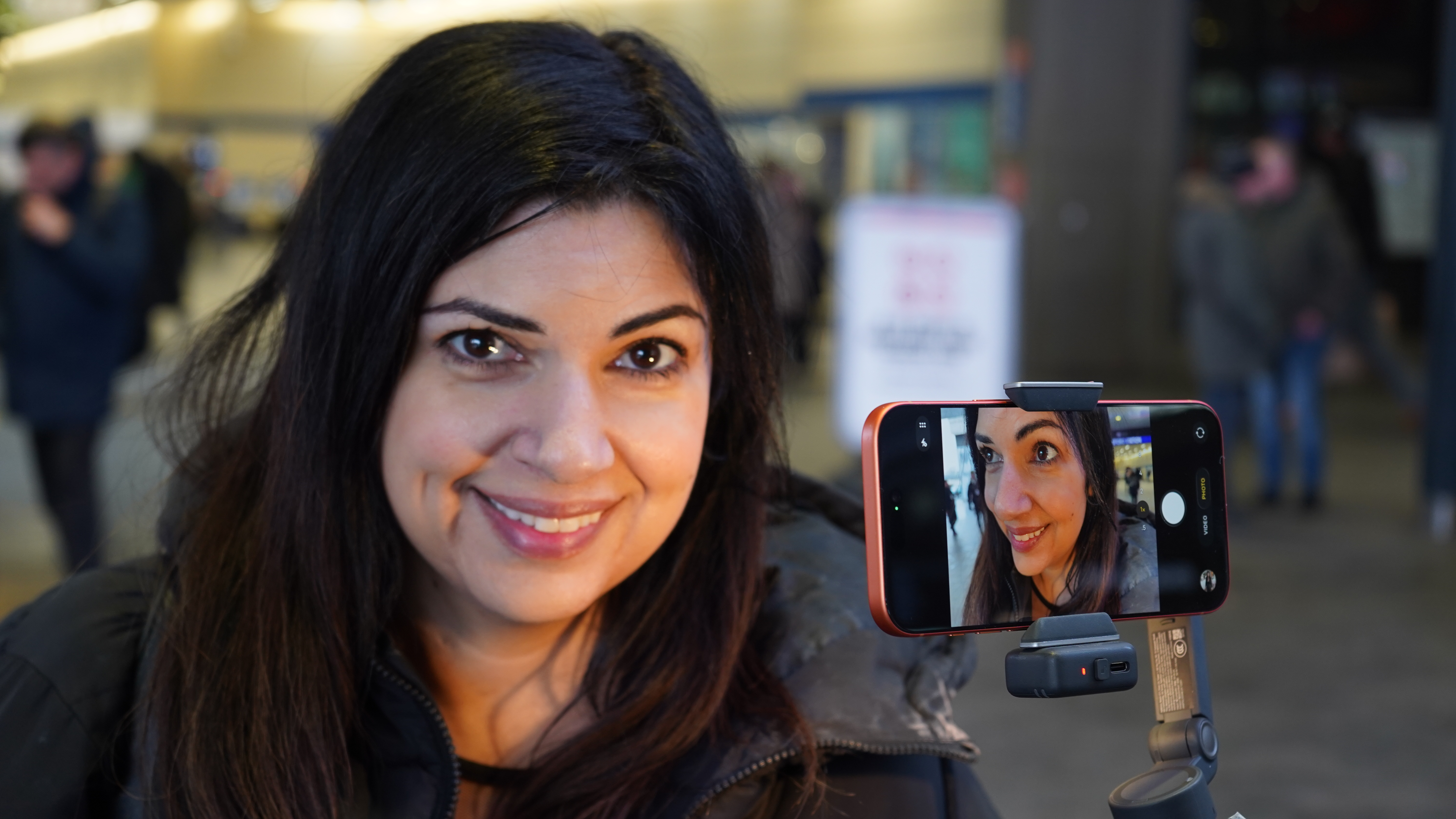 Ariane Sherine shooting a selfie with the DJI Osmo Mobile 8 and an iPhone 17 Pro Max