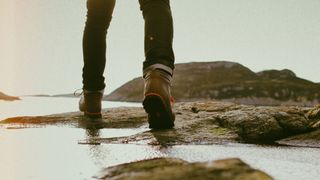 a person walking in the wilderness in a pair of hiking boots