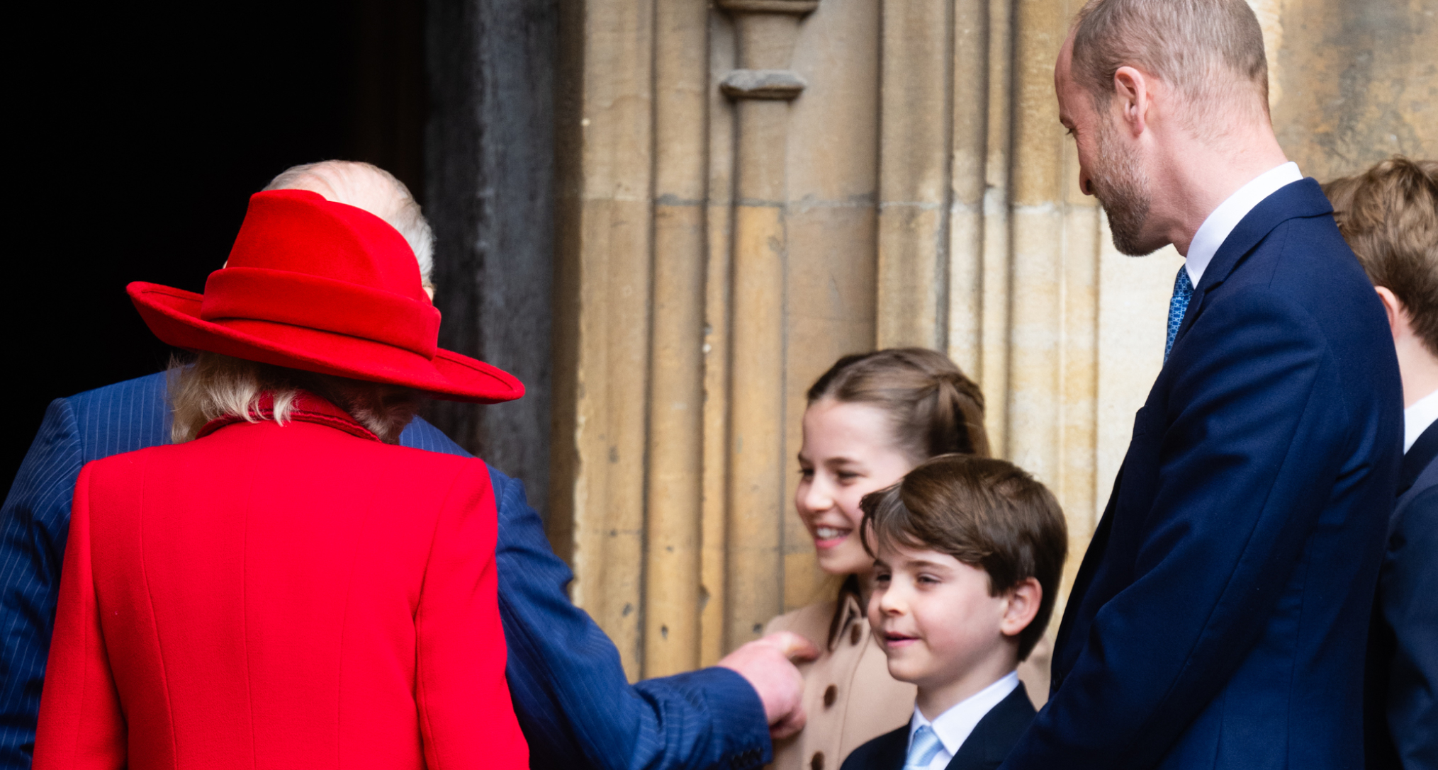 King Charles and Queen Camilla walking into church next to Charlotte, Louis and William