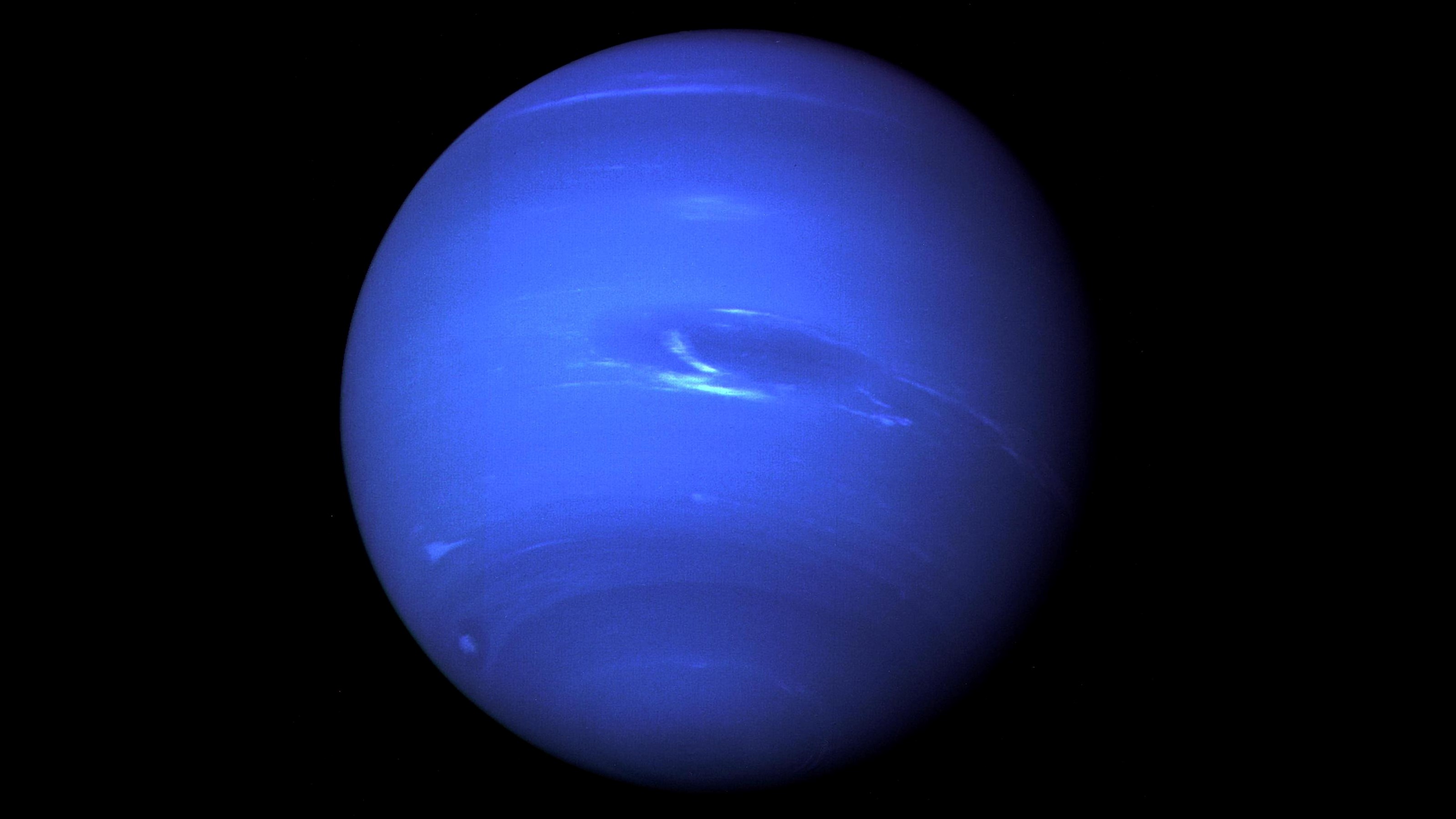 Deep blue Neptune against black backdrop of space.