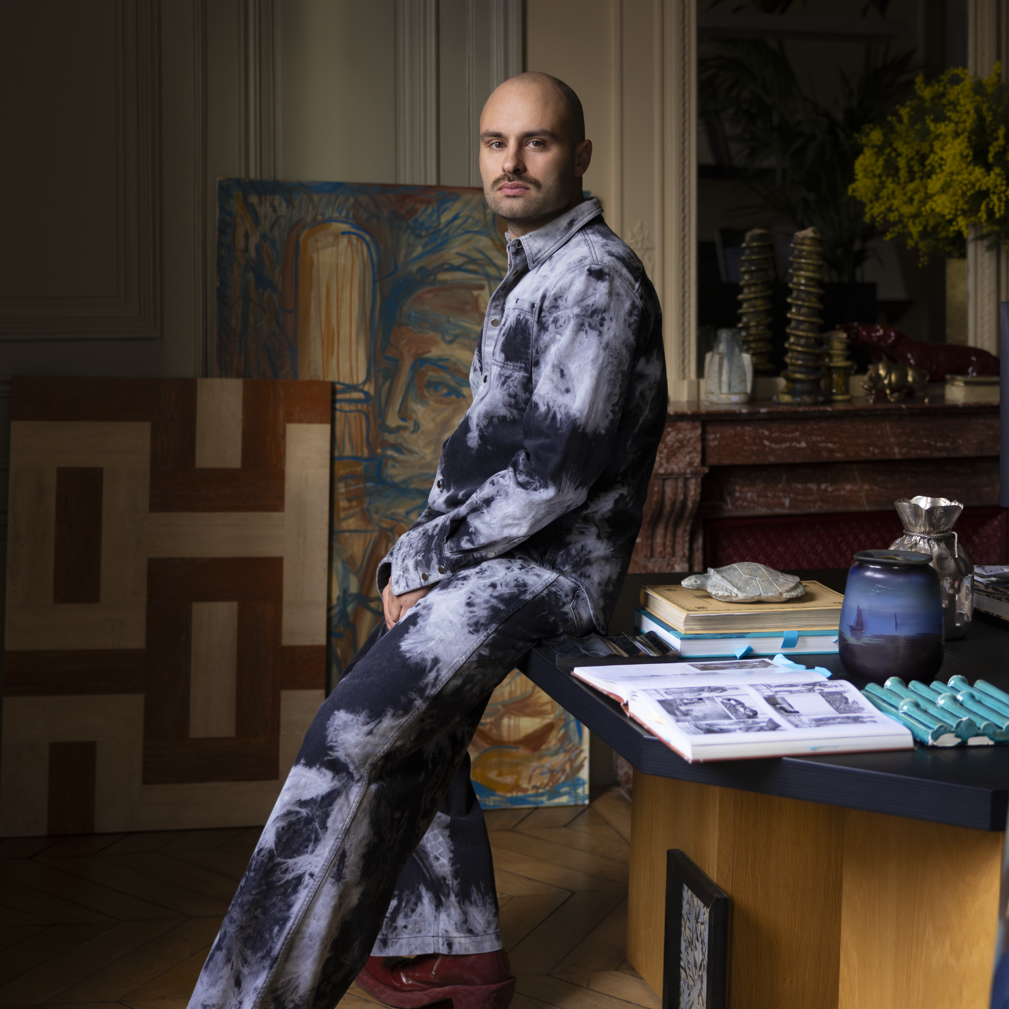Hugo Toro designer profile image in office wearing purple suit