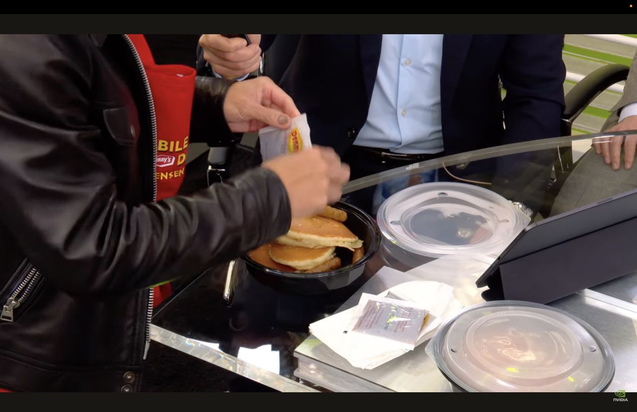 Jensen Huang serving Nvidia Breakfast Bytes to the Live at Nvidia GTC with Acquired hosts and guests