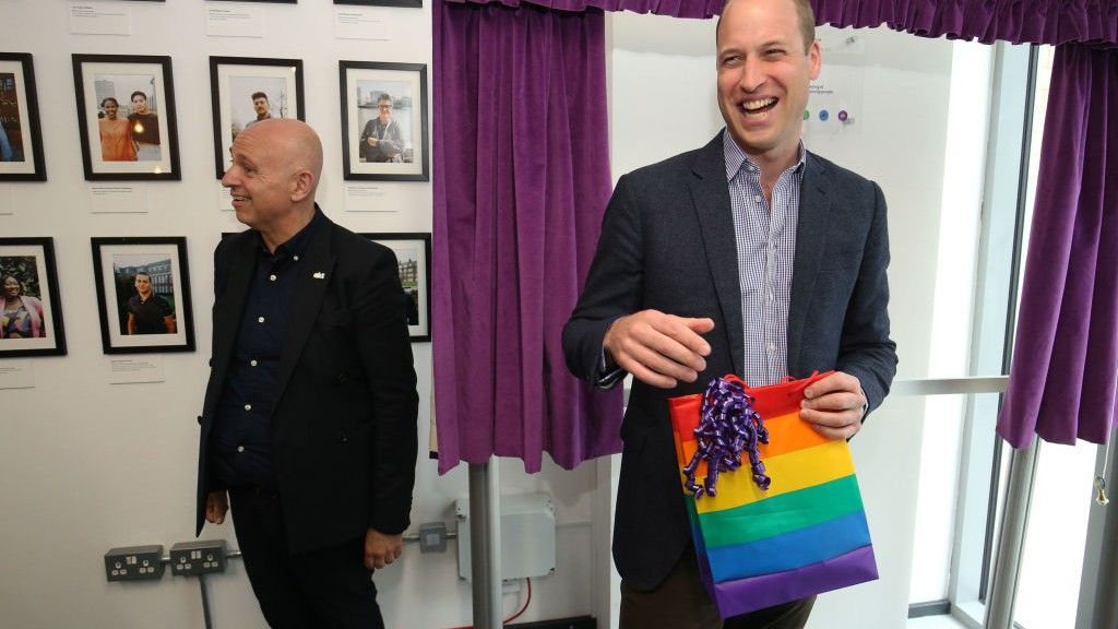 Britain&#039;s Prince William, Duke of Cambridge, reacts to receiving a gift bag from trust chief executive officer Tim Sigsworth during a visit to the Albert Kennedy Trust in London to learn about the issue of LGBTQ youth homelessness in London on June 26, 2019.