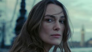 Keira Knightley looks to the side grimly in Black Doves.