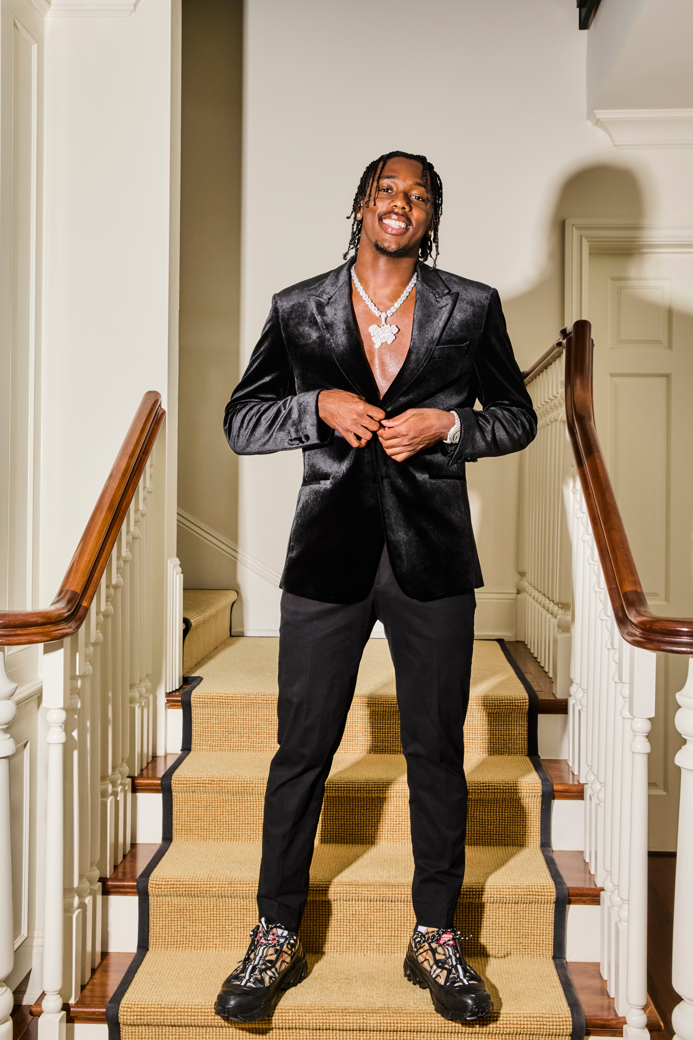 hercy miller in a black suit on a set of stairs in a promotional shot for calabasas confidential