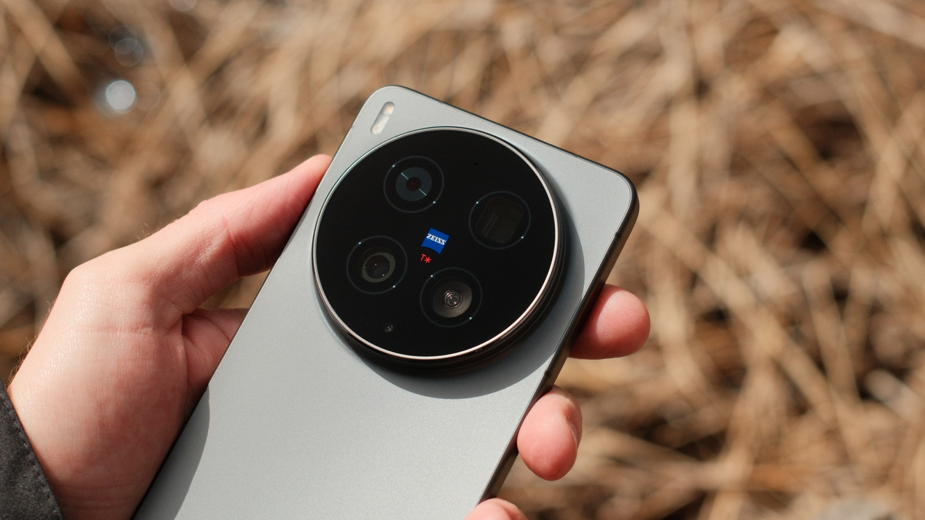 Vivo X300 Ultra rear camera module photographed against dry grass