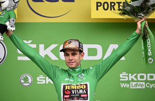 JumboVisma teams Belgian rider Wout Van Aert wearing the sprinters green jersey celebrates on the podium after the 5th stage of the 109th edition of the Tour de France cycling race 1537 km between Lille and Arenberg Porte du Hainaut in northern France on July 6 2022 Photo by Marco BERTORELLO AFP Photo by MARCO BERTORELLOAFP via Getty Images