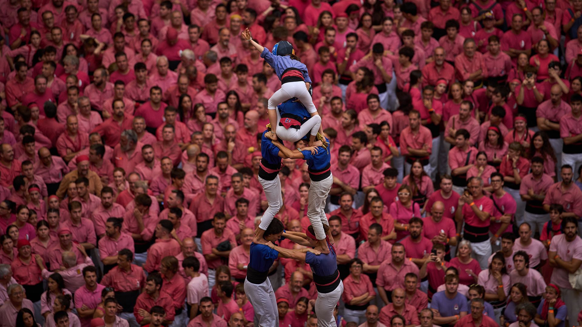 Members of Castellers de la Vila de Gr&agrave;cia form a 