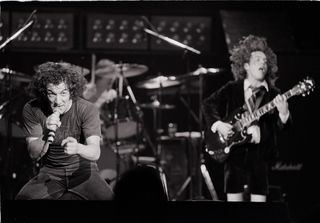 Brian Johnson (left) and Angus Young perform onstage with AC/DC in 1981