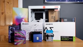 All the parts for this white gaming PC build on a table.