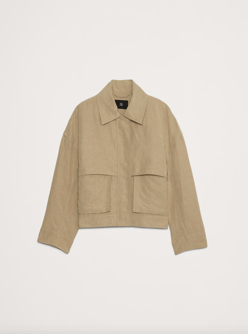 a linen work jacket in front of a plain backdrop